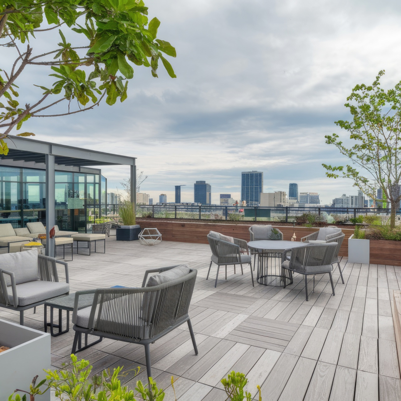Relaxing outdoor space on a rooftop patio with comfortable seating and panoramic city views